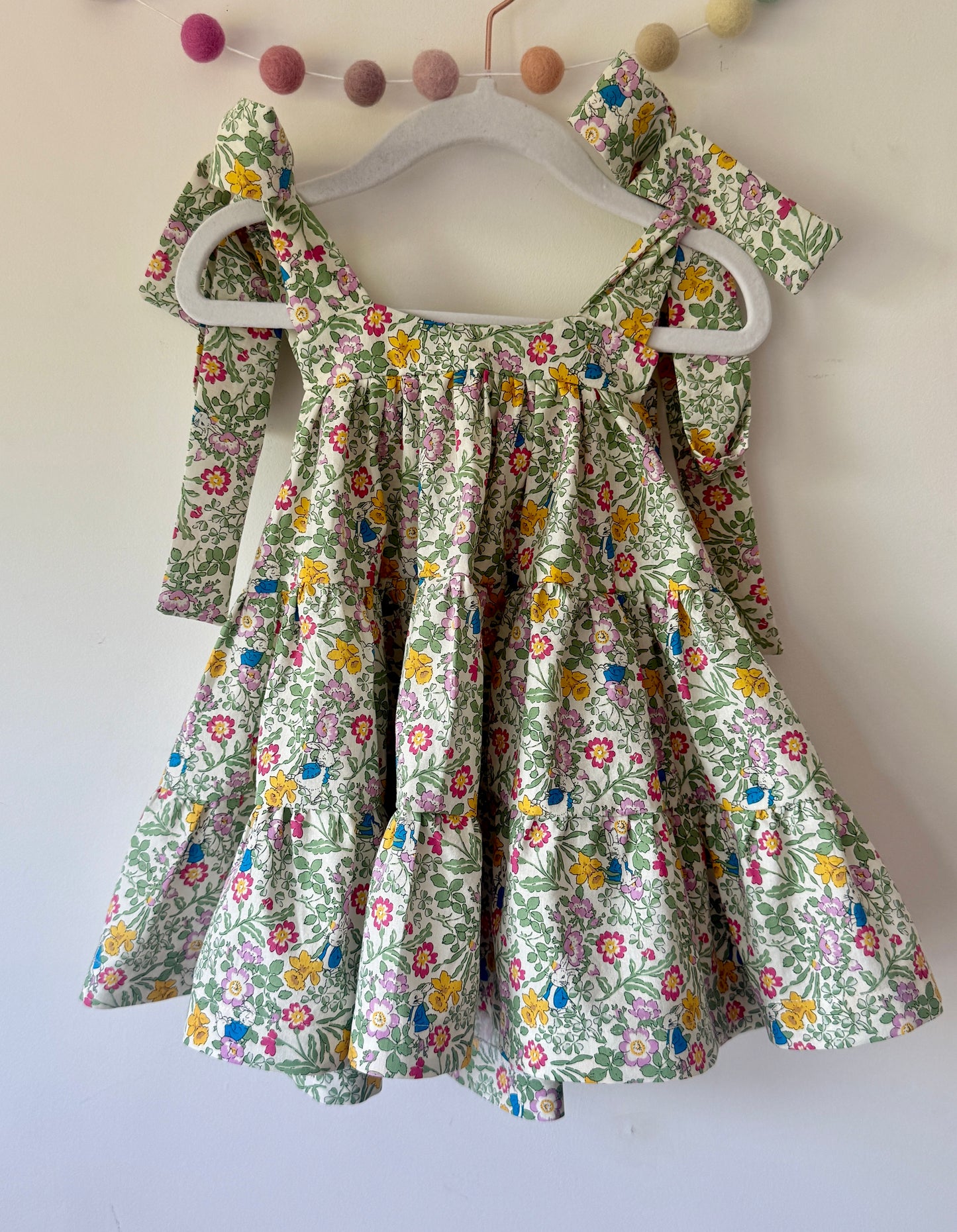Girls strappy tiered dress with rabbit and floral garden detail