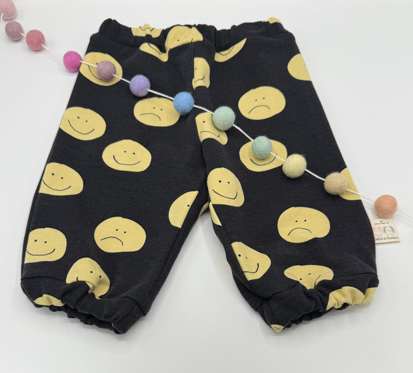 Black sustainable Unisex Kids Sweatpants with happy/sad faces