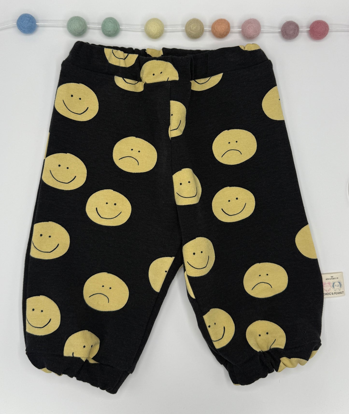 Black sustainable Unisex Kids Sweatpants with happy/sad faces