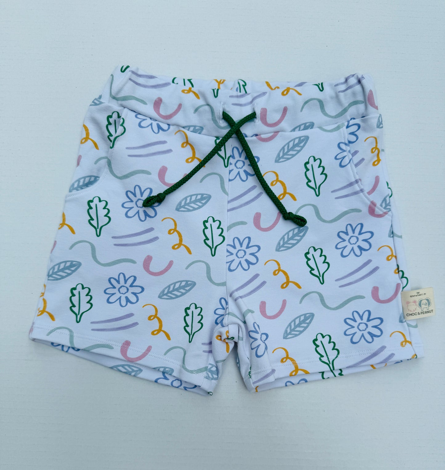 Unisex shorts with floral and line detail in pastel colours. Sustainable fabric.