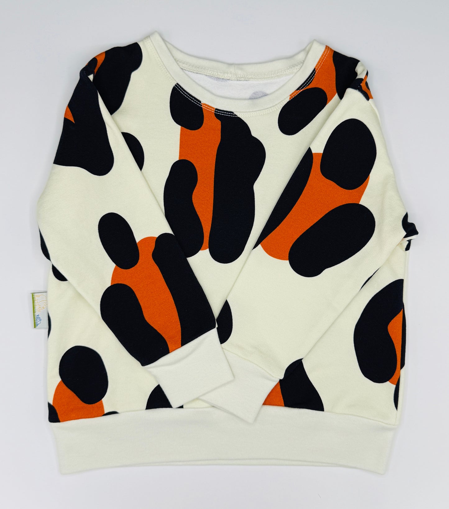 Unisex kids jumper. White sweatshirt with black and orange abstract pattern on a white background