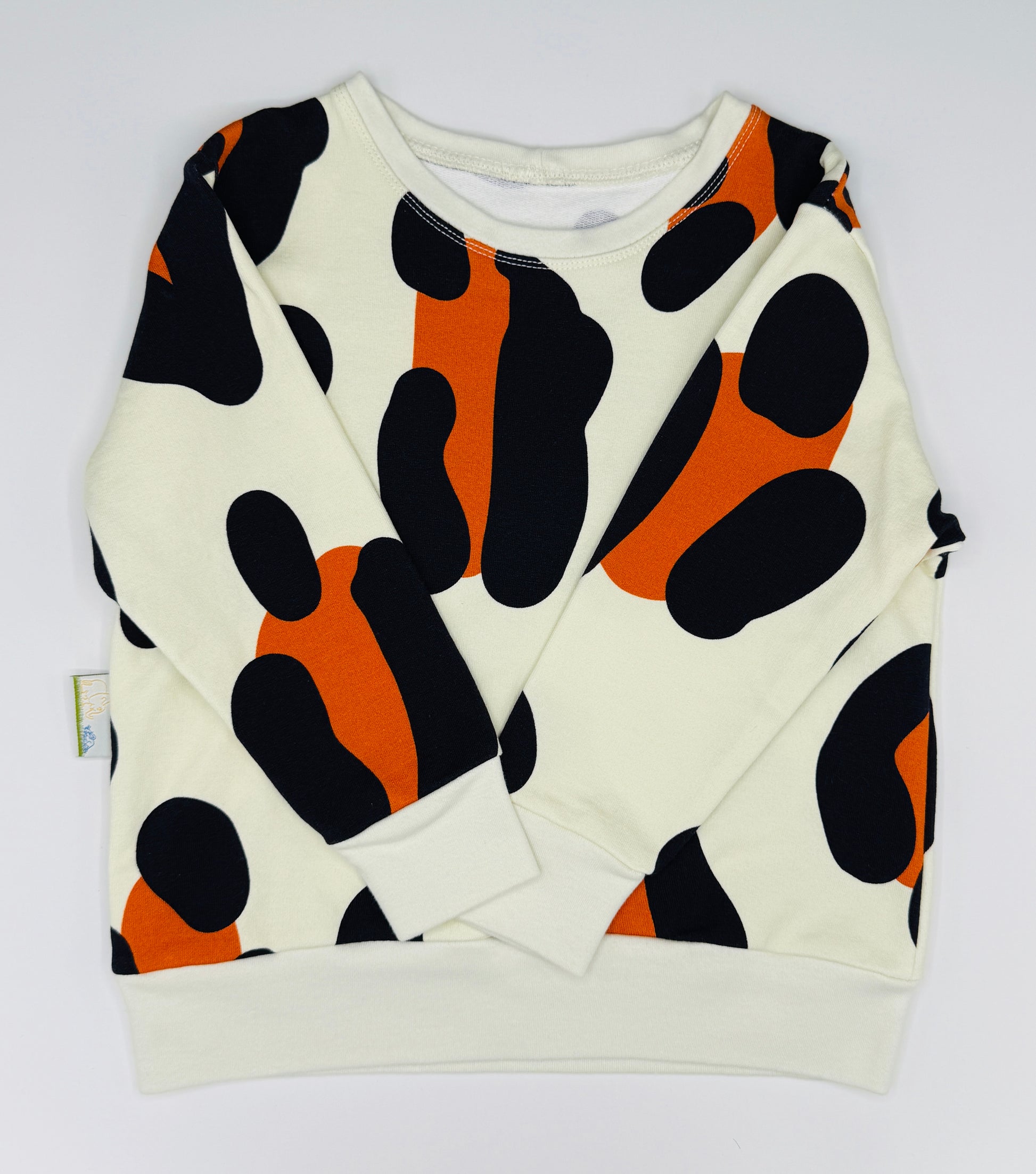 Unisex kids jumper. White sweatshirt with black and orange abstract pattern on a white background