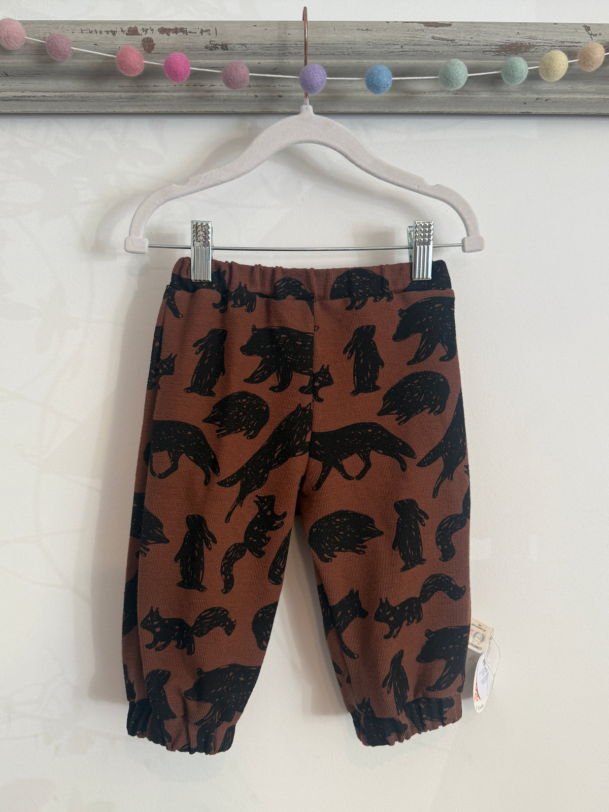 Brown OEKO-TEX unisex sweatpants with standout black wild animals such as hedgehogs, wolves, foxes, rabbits, squirrels. Has elasticated waist and cuffs for extra stretch 